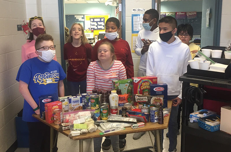 middle-school-studets-with-food-drive-items
